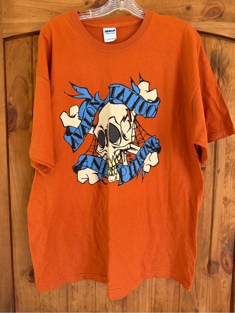 Gildan Orange Tee with Blue & Cream Skull Graphic Avalon Tattoo and Piercing